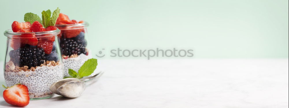 Similar – Berry-fruity water, iced with raspberries, blueberries, ice cubes and drinking straw on white background