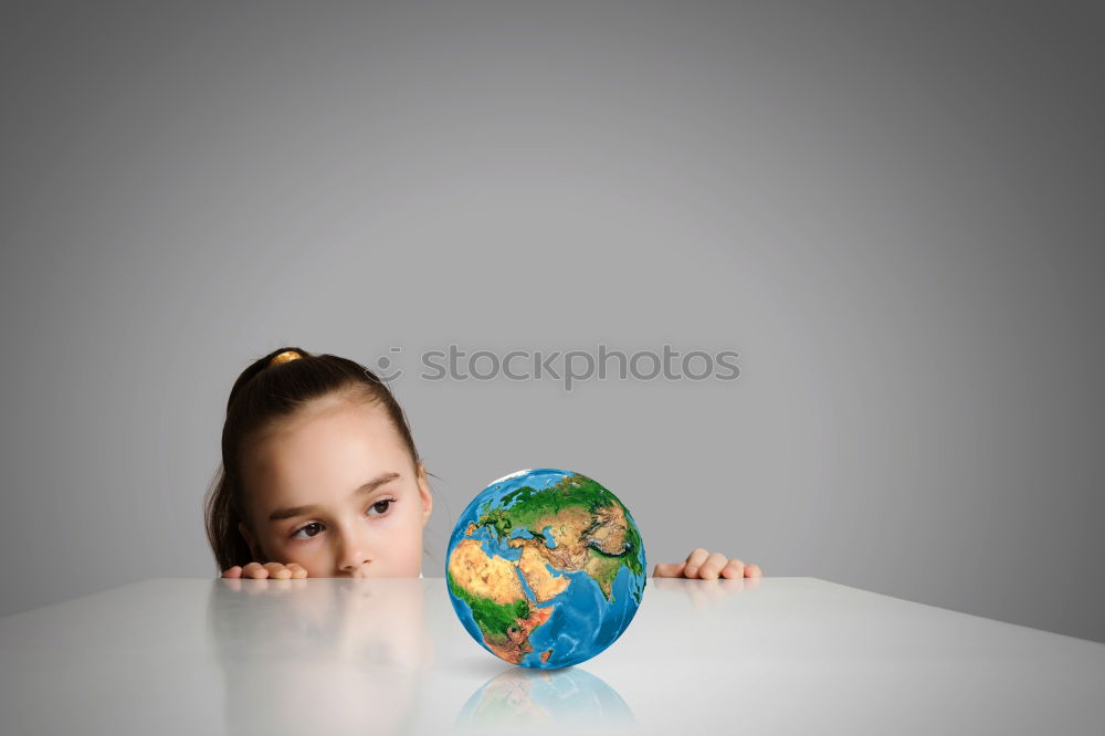 Similar – Pupil girl pointing at globe