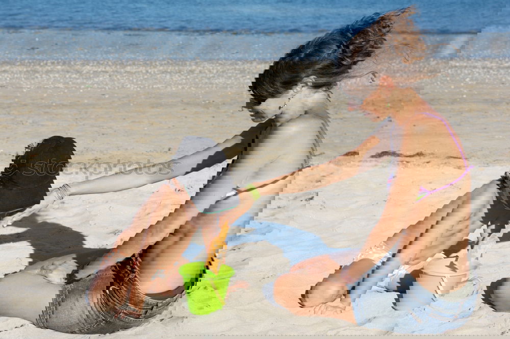 Image, Stock Photo Mother throwing sunscreen on her little daughter on a tropical beach