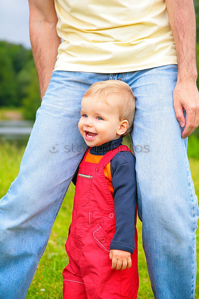 Similar – Image, Stock Photo Caring father feeding his baby son from the bottle in the park