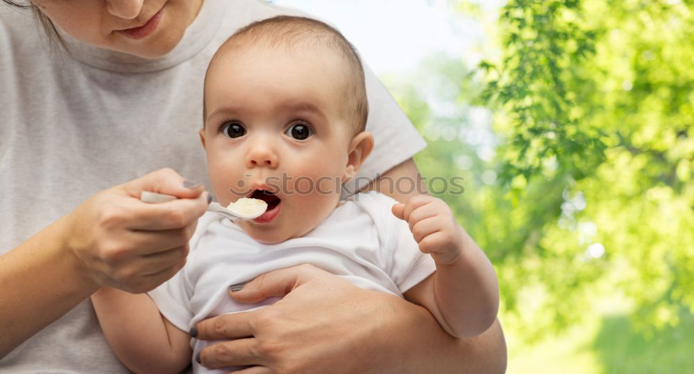 Similar – Daddy feeding toddler a spoonful of baby food