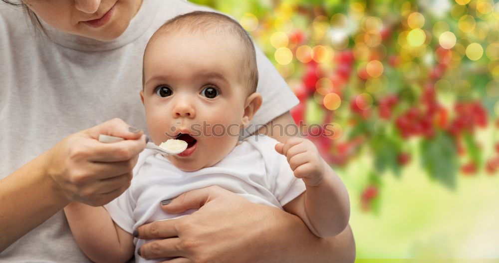 Similar – Daddy feeding toddler a spoonful of baby food