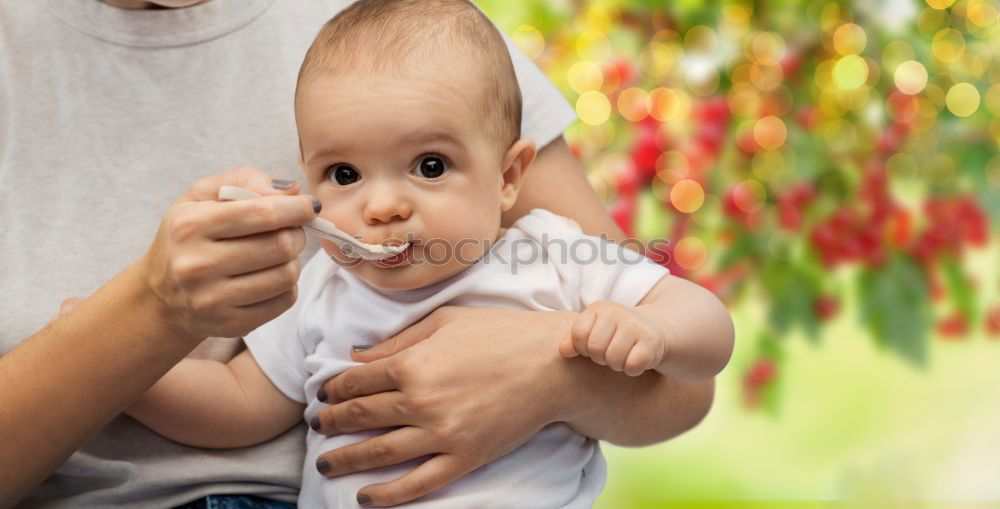 Similar – Daddy feeding toddler a spoonful of baby food