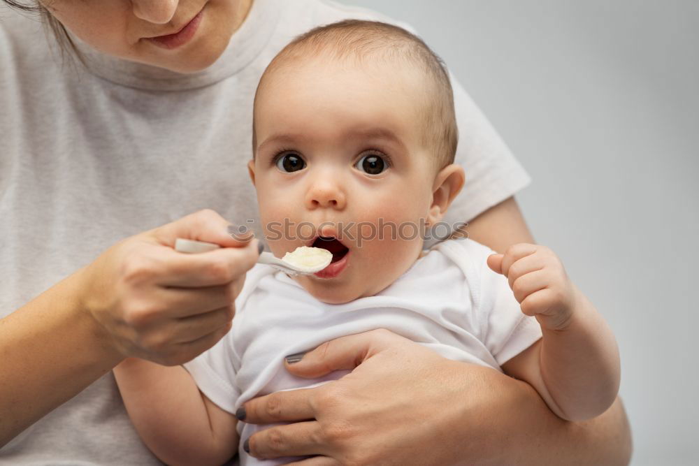 Similar – Daddy feeding toddler a spoonful of baby food