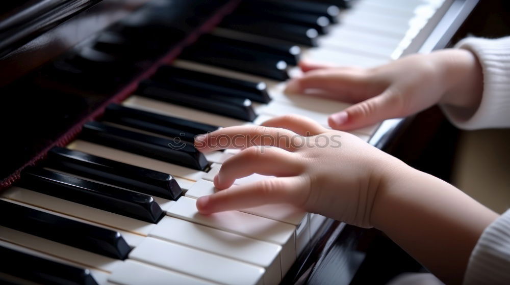 Similar – Toddler plays piano with delicate hands