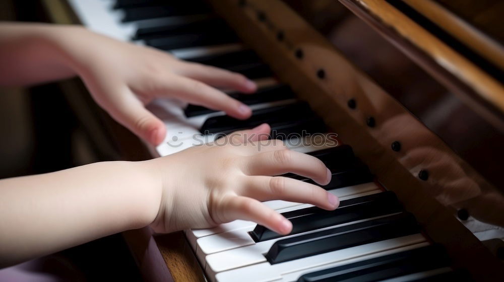 Similar – Toddler plays piano with delicate hands