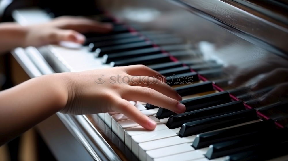 Toddler plays piano with delicate hands