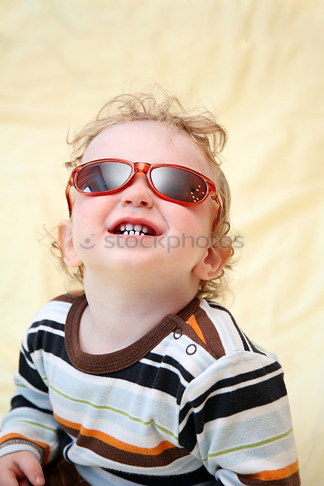 Funny boy smiling sitting inside a suitcase