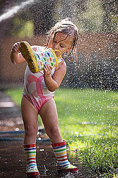 Similar – Little boy jumps into a puddle that makes the water run high