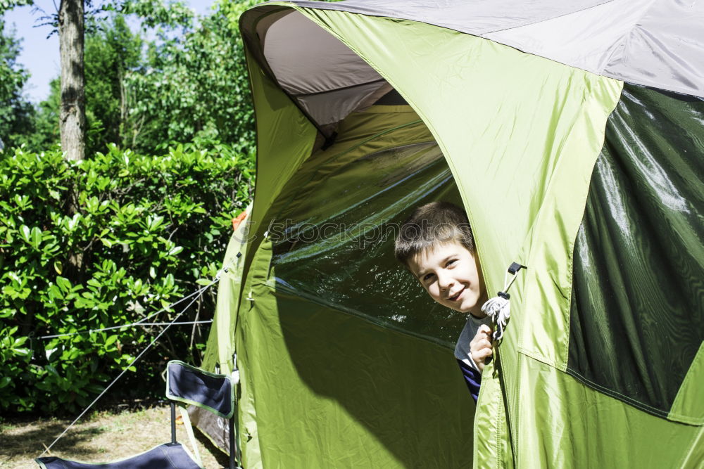 Similar – Couple planning next trip while sitting with map in tent. People relaxing in tent at camping during summer vacation