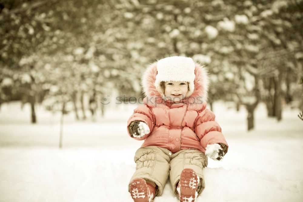 Similar – Teenage girl pulling sled with her little sister through forest