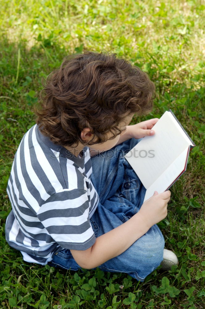 Similar – Image, Stock Photo Little baby girl watching a book with pictures