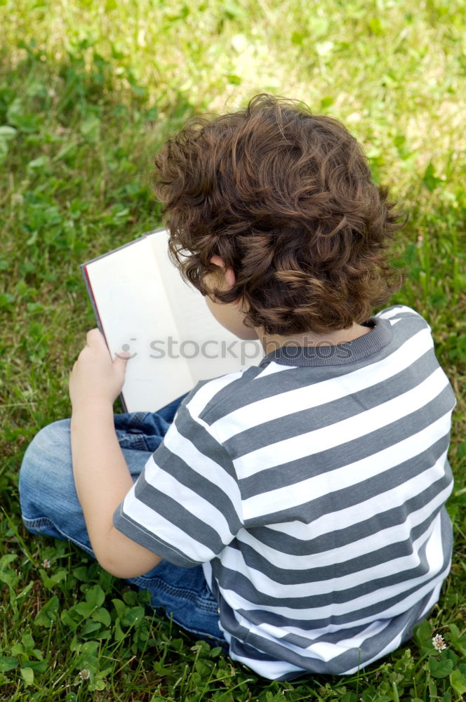 Similar – Image, Stock Photo Little baby girl watching a book with pictures