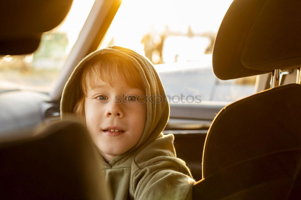 Similar – Image, Stock Photo One little boy sitting in the car and look out from the car window at the day time. Concept of happy trip.