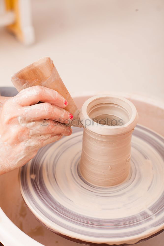 Similar – Image, Stock Photo Young female sitting by table and making clay or ceramic