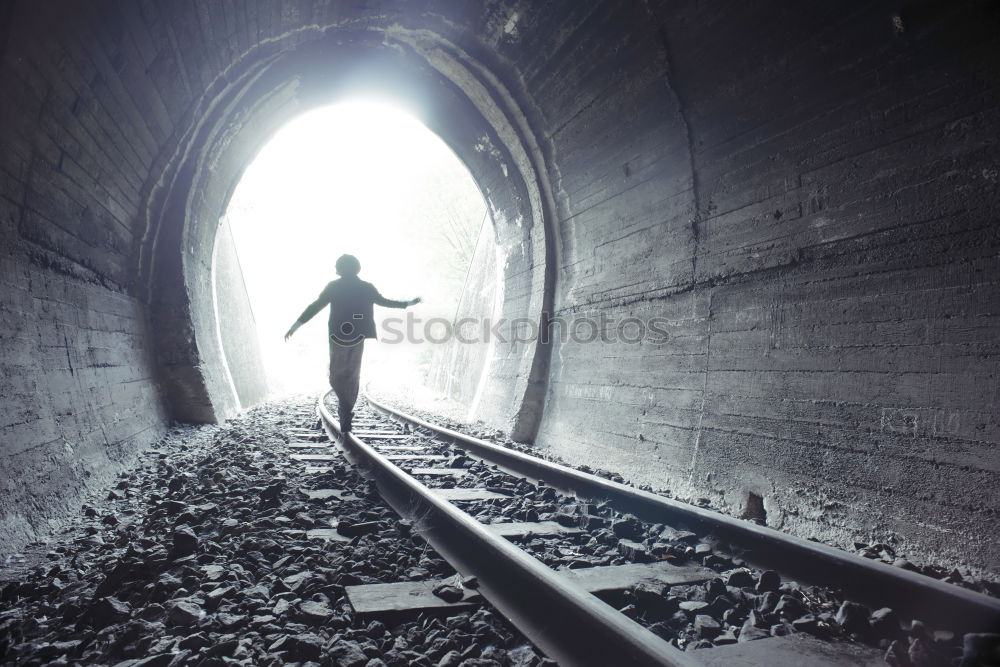 Similar – Man with dog is walking on a path in dense fog