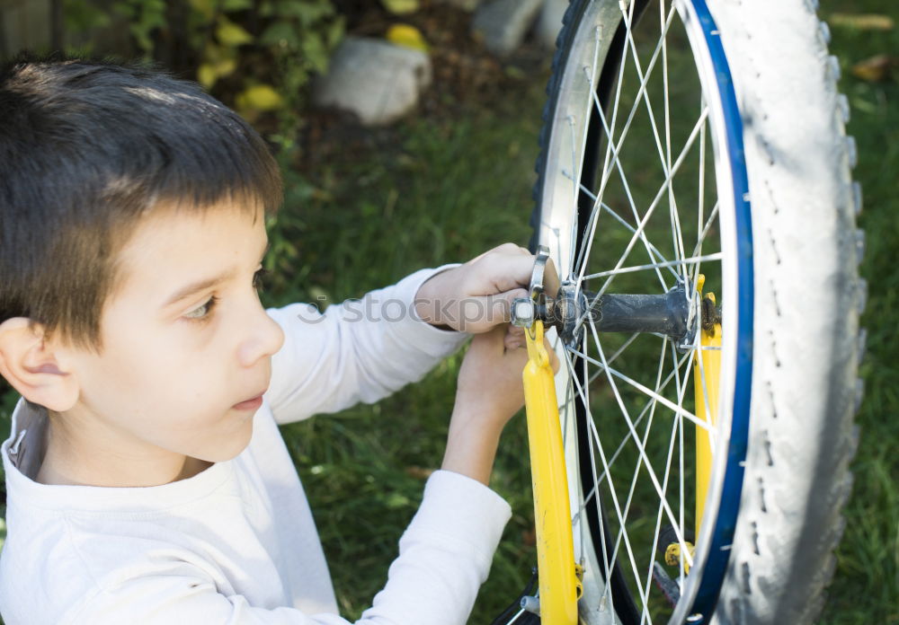 father and daughter fixing problems with bicycle outdoor