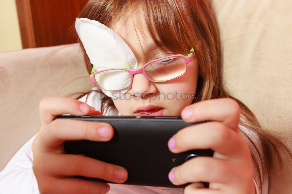 Similar – Sweet blondie girl playing on a Tablet PC.