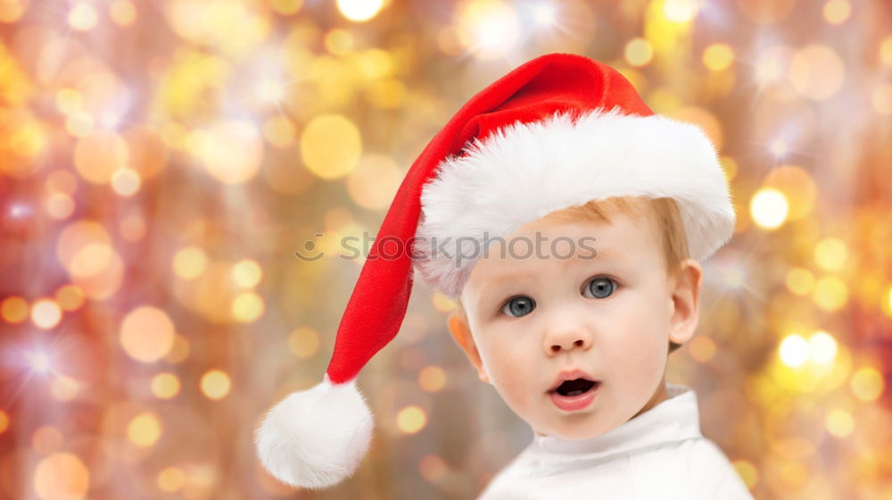 Adorable kid with Santa´s hat on Christmas day.