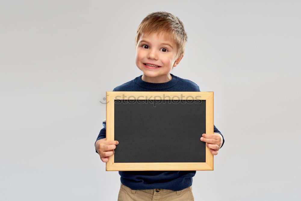 Similar – Image, Stock Photo smiling child holding a blackboard