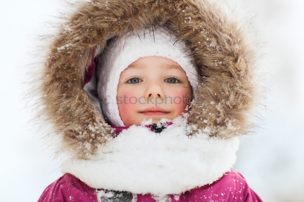 Similar – baby girl in knitted scarf walking in winter forest