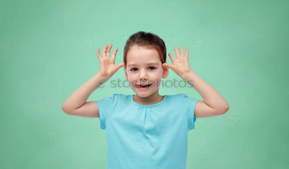 portrait of angry girl on blue background