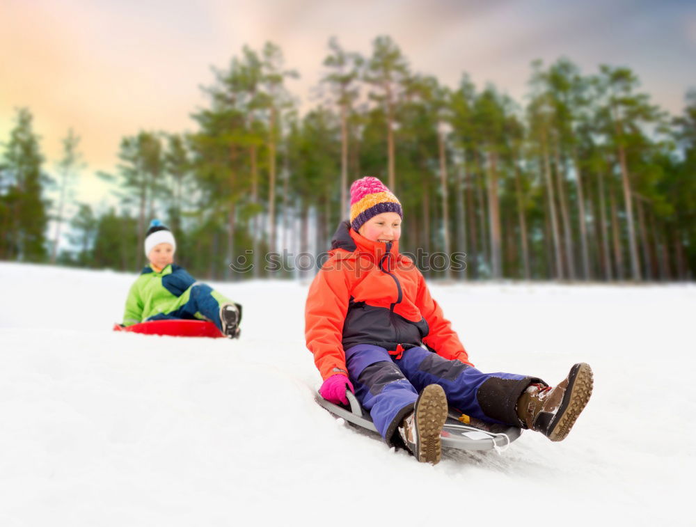 Similar – Young family with children go sledding in winter sunshine