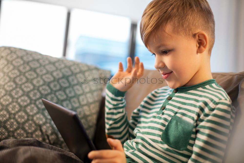 Similar – Mother reading a book to her baby son