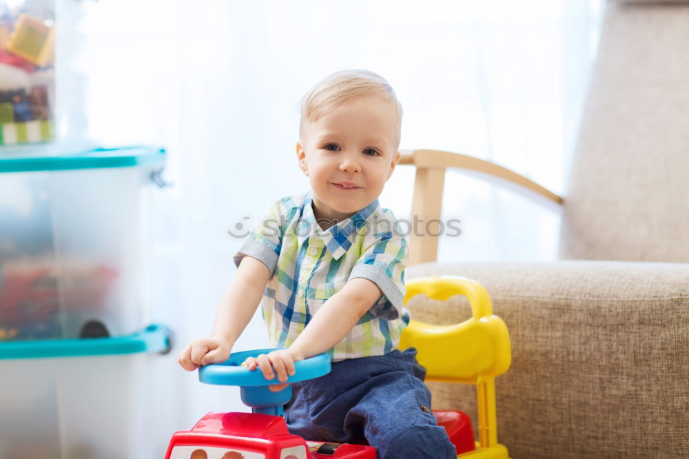 Similar – Baby toddler sits interested and curious in front of washing machine on the floor