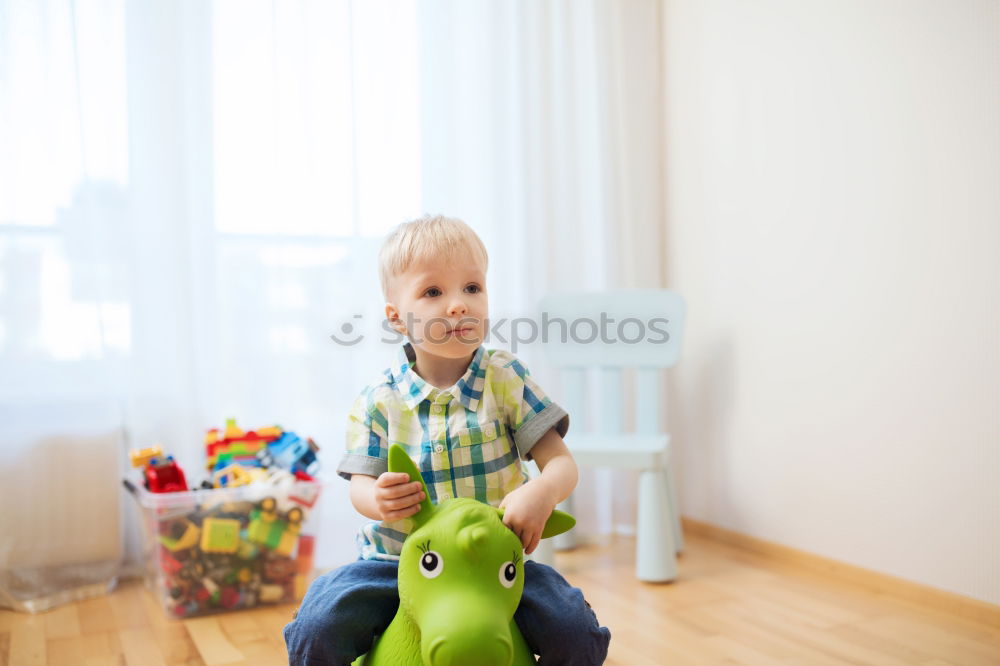 Similar – Toddler boy playing with new toy wearing pyjamas