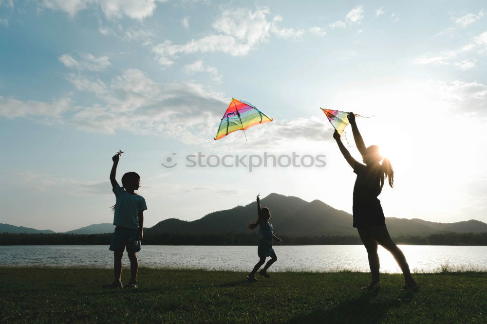 Similar – Father and daughter with balloons playing on the beach