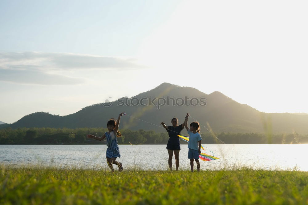 Image, Stock Photo Happy family standing near the lake at the day time.