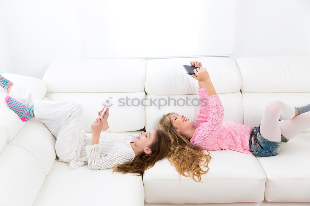 Similar – Image, Stock Photo Young girl looking at mobile phone while sitting on bed