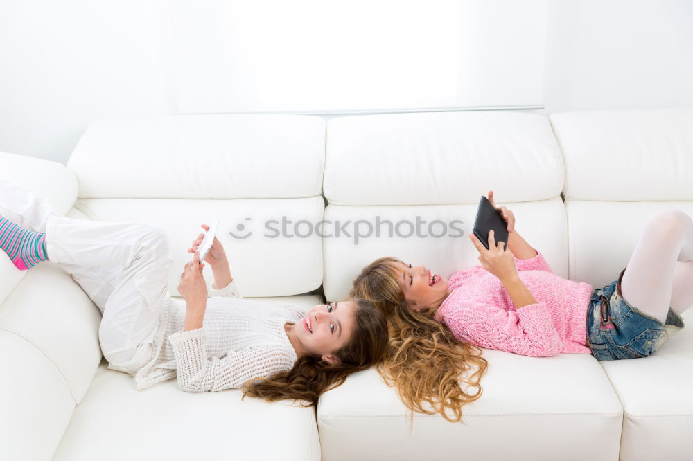 Similar – Image, Stock Photo Young girl looking at mobile phone while sitting on bed