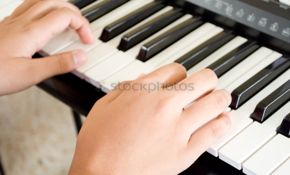 Similar – Toddler plays piano with delicate hands