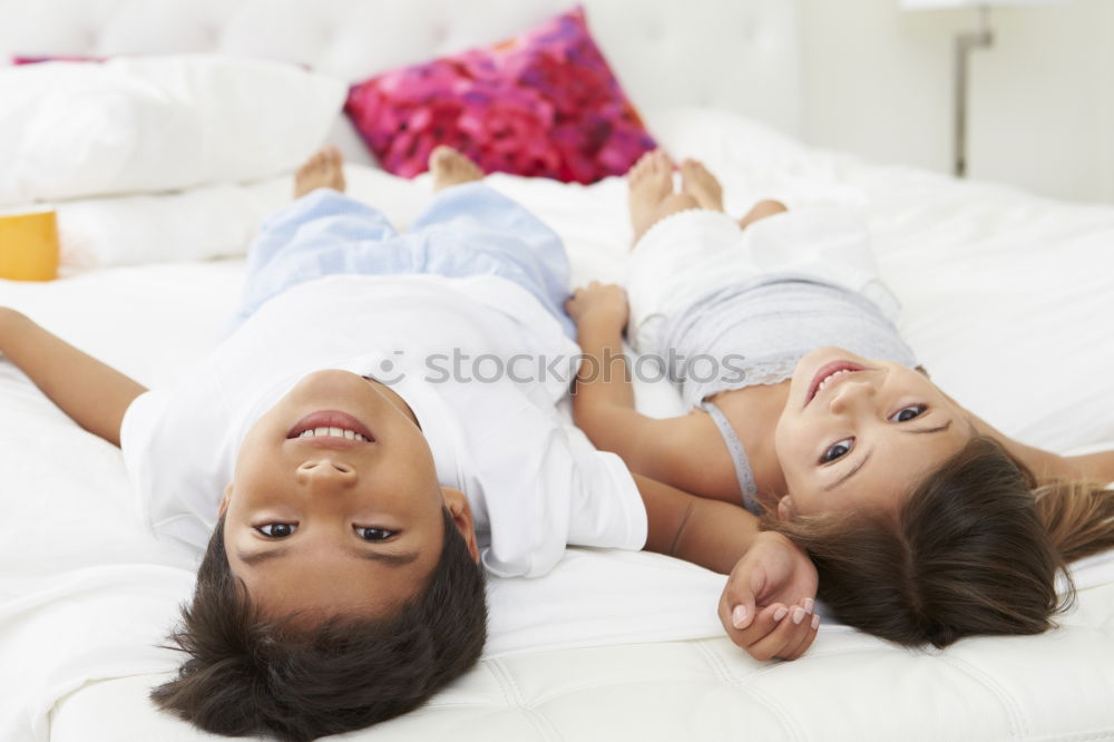 Similar – Two beautiful sisters playing on bed