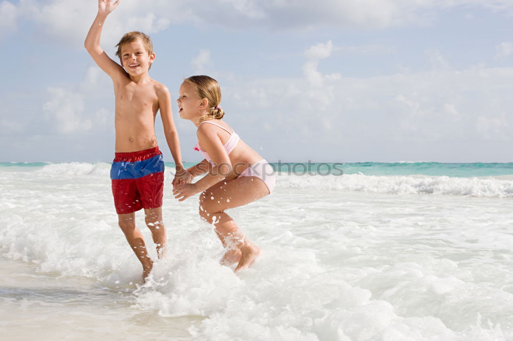 Similar – Image, Stock Photo caucasian mother and son playing with windmill at the beach