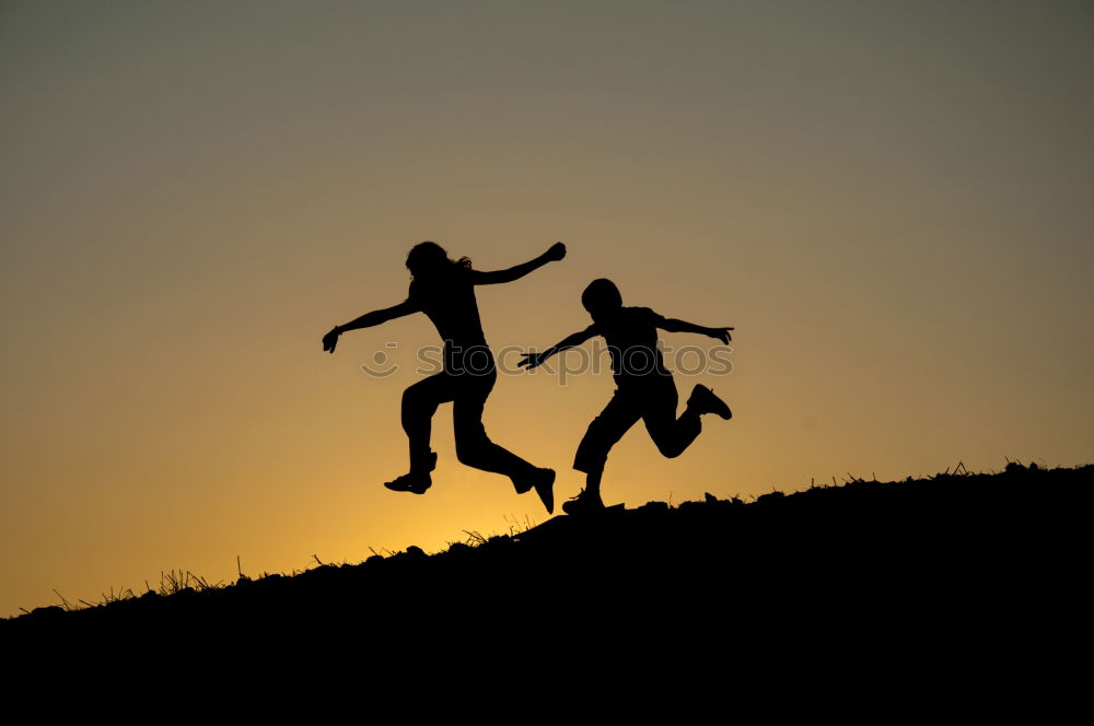 Similar – Mother and son holding hands on a beach at sunset