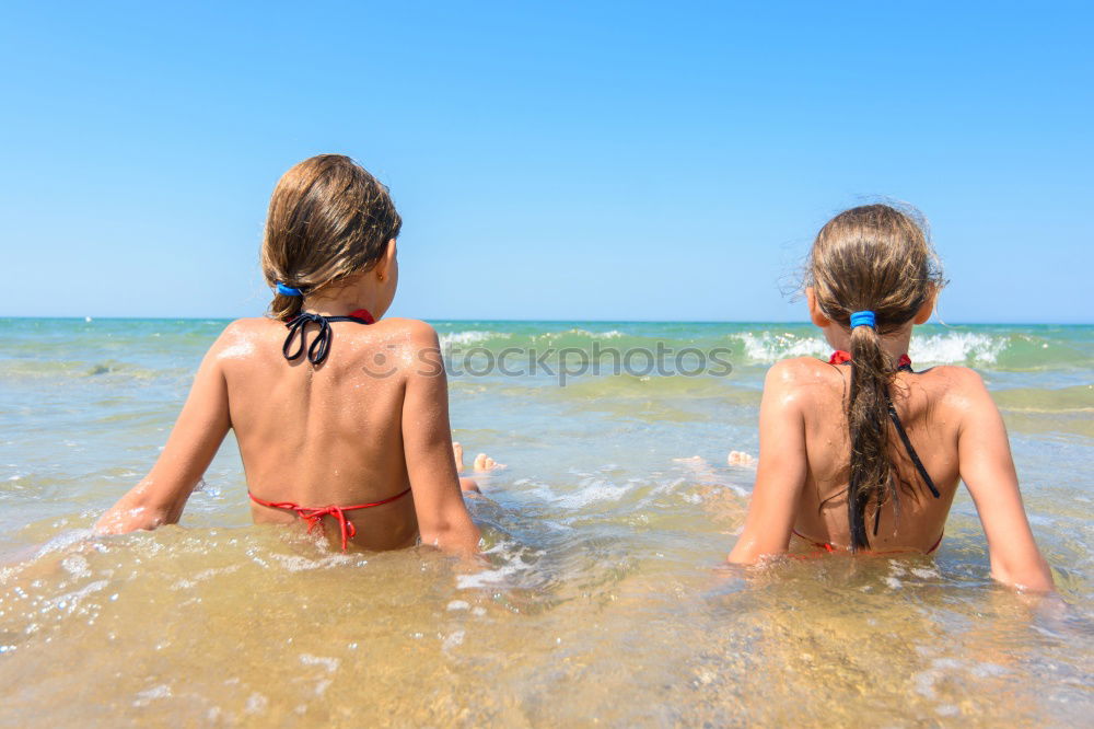 Similar – Image, Stock Photo Mother throwing sunscreen on her little daughter on a tropical beach