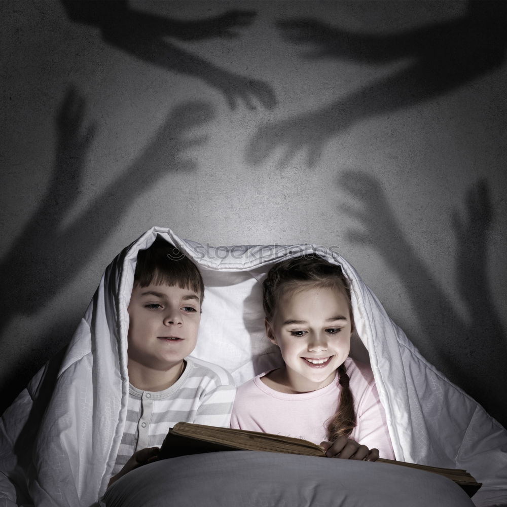 Similar – Image, Stock Photo Brothers looking at the tablet in the dark