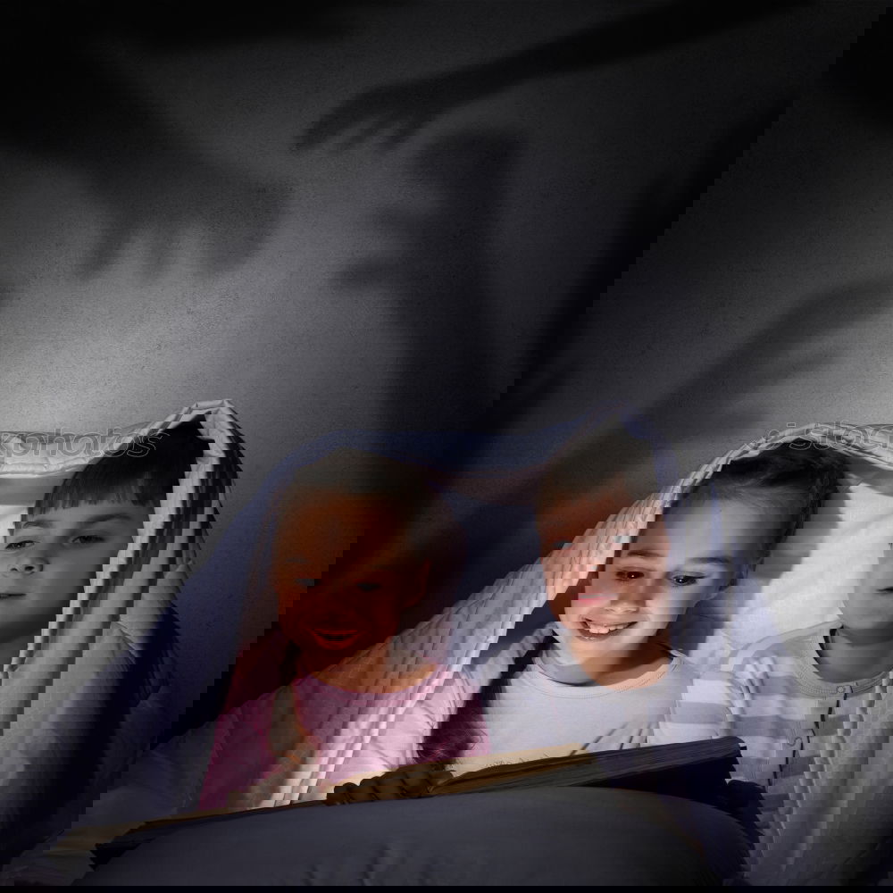 Similar – Image, Stock Photo Kids sitting on the bed looking tablet in the dark