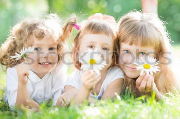 Similar – Three happy children playing in the park at the day time.