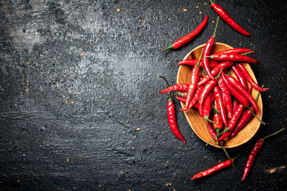 Similar – Image, Stock Photo Red hot chili peppers on a wooden background