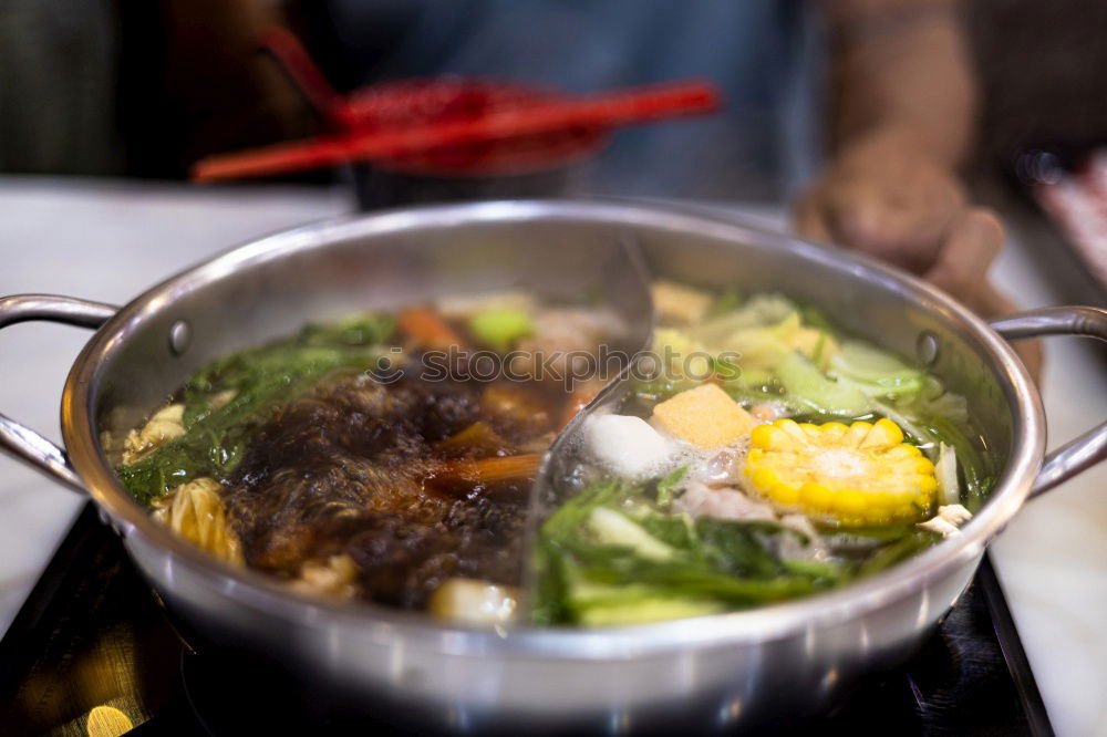 Similar – Korean hot pot and people taking food with chopsticks.