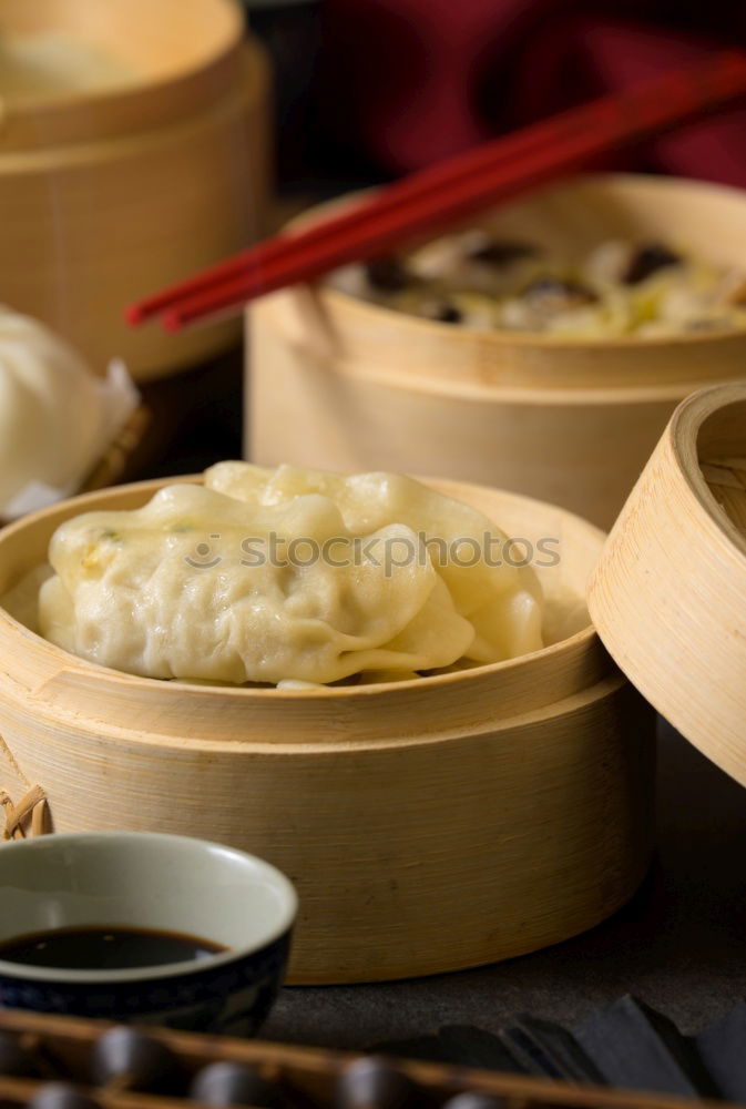 Similar – Dumplings or gyoza served in traditional steamer