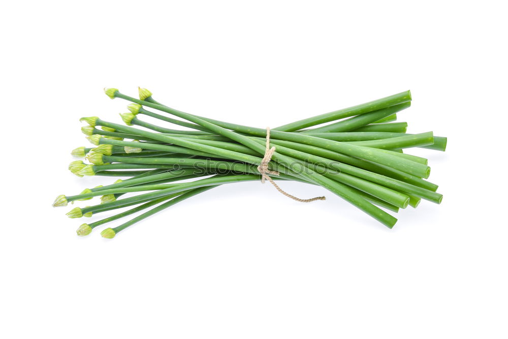 Similar – A portion of green asparagus, freshly harvested from the local field, decorated with a plaid ribbon of cloth, tied together, lies in the light on the table, on a white cloth of linen.