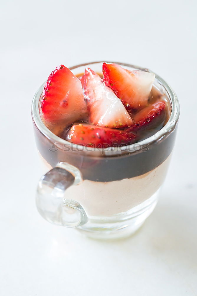 Similar – Berry-fruity water, iced with raspberries, blueberries, ice cubes and drinking straw on white background