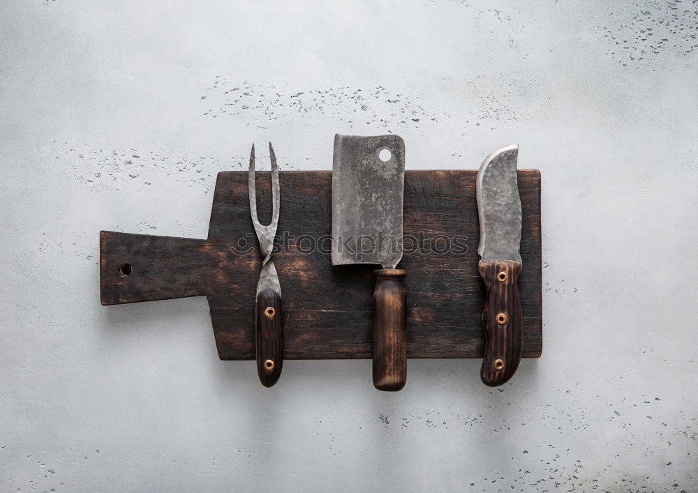 Similar – kitchen brown cutting board with handle and knife