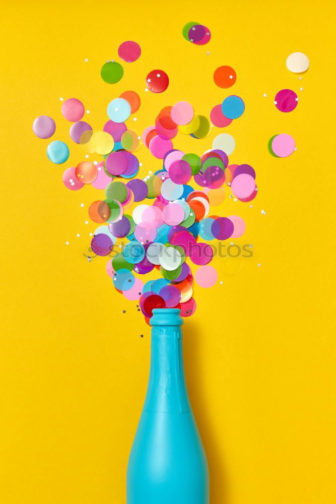 Black woman with afro hair celebrating with confetti.