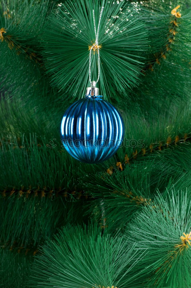 Similar – a matt golden Christmas bauble hangs from the branch of a Christmas tree